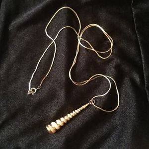 Conical shell with gold tone and 30" chain